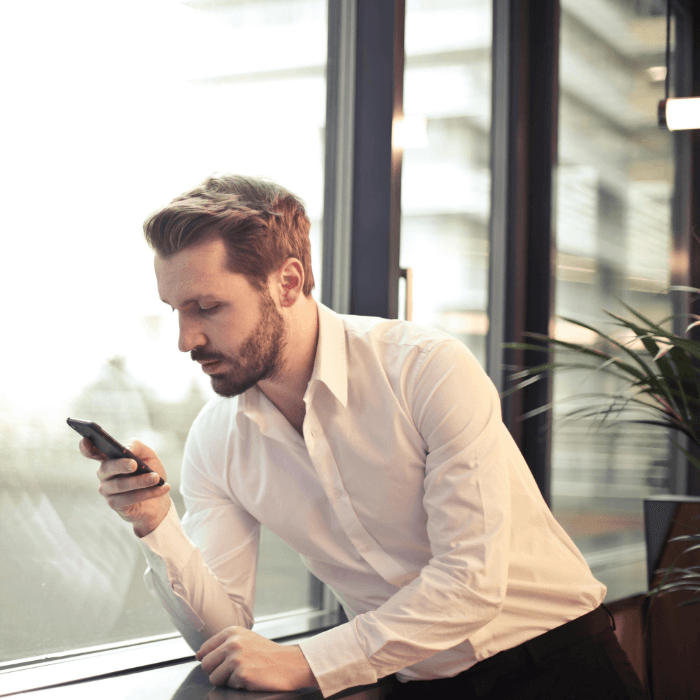 Consultant reviewing funding updates on a phone